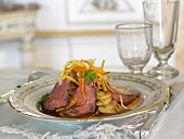 Roast beef with julienned vegetables and fried potatoes