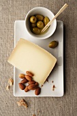 A slice of mountain cheese, almonds and olives
