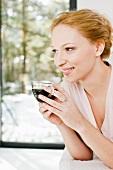 A young woman drinking a cup of coffee