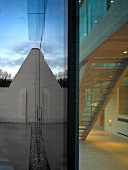 Terrace in front of glass wall on contemporary house with view of illuminated stairwell