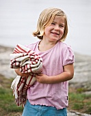 Girl carrying picnic blanket