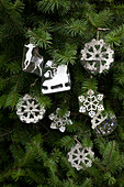Christmas decorations with snowflake motif hanging on Christmas tree