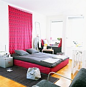 Bed room with pink tapestry and grey bed linen
