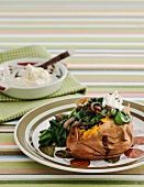 Baked sweet potato with feta, spinach and red onions
