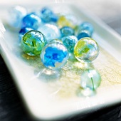 Colourful glass marbles on a tray