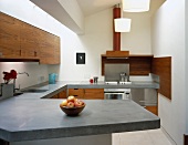 Designer kitchen with wooden doors and concrete work surfaces