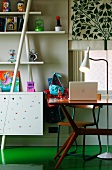 Detail of child's bedroom with fifties-style desk and standard lamp