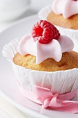 Raspberry muffins in white paper cases with pink bows