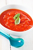 A bowl of fresh tomato sauce with plastic spoons