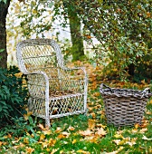 Weathered rattan armchair and basket on lawn