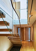 Wooden staircase with glass balustrade