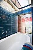 Bathroom with blue tiles and skylight