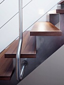 Wooden treads on stainless steel stringer and wire cable balustrade