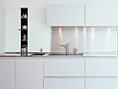 Detail of kitchen unit with white doors