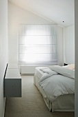 White bedroom with closed blinds on window