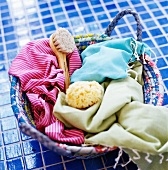 Bathing utensils in a basket on blue tiles