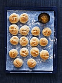 Scones with jam on a baking tray