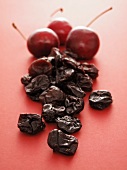 Small Wooden Bowl of Dried Cherries with a Fresh Cherry