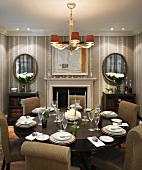 Upholstered chairs around festive, set table in traditional dining room