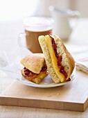 Bacon and Egg Breakfast Sandwich; Halved; Coffee