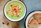 Cream of broccoli soup with shrimp and sliced almonds