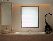 Detail of designer bathroom with marble-clad bathtub