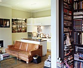 View through doorway of old leather couch against kitchen counter