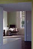 Anteroom with wide doorway and view of armchair in corner of room