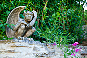 Bronze mythological figurine on garden wall