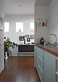 Modern kitchen counter in niche and view of sideboard through floor-to-ceiling doorway
