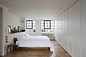 Modern furnishings in bedroom with old floorboards