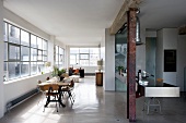 Vintage-style dining area and designer kitchen in loft apartment