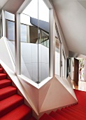 Staircase with red carpet in contemporary apartment building with futuristic ambiance