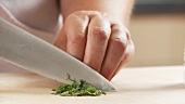 Chopping sage leaves into strips