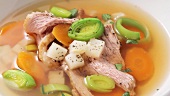 Clear beef broth with garnish