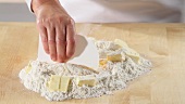 Chopping dough ingredients together using a scraper