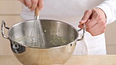 Beating crème in round-bottomed metal mixing bowl