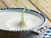 Milk splashing out of a bowl