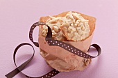 Vanilla cookies with almond slivers in a paper bag