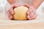 Hands on ball of dough