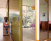 View through open door into bedroom with view of garden