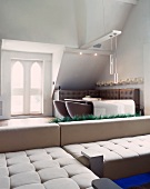 Light, designer corner couch in front of stylish dining area in a classic setting
