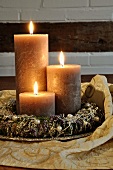 Festive table decor with wreath & three candles on silver plate