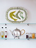 Glass shelf with platter, teapot, spices & oils