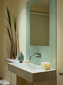 Modern bathroom in pastel tones - designer basin decorated with candles and grasses