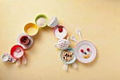 Caterpillar of colourful crockery with breakfast foods