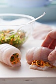 Preparing fish rolls stuffed with vegetables