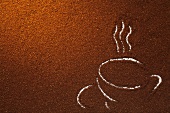 Coffee grounds with traced outline of coffee cup