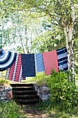 Carpets hanging from a clothes line in the garden