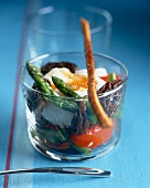 Poached egg on salad with morels and green asparagus